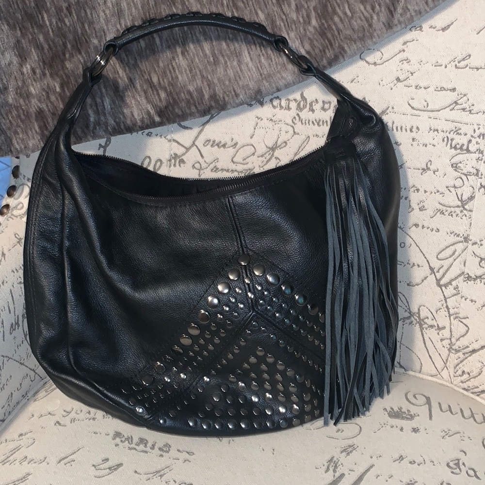 Black leather. Gun metal studs. Tassel zipper.
